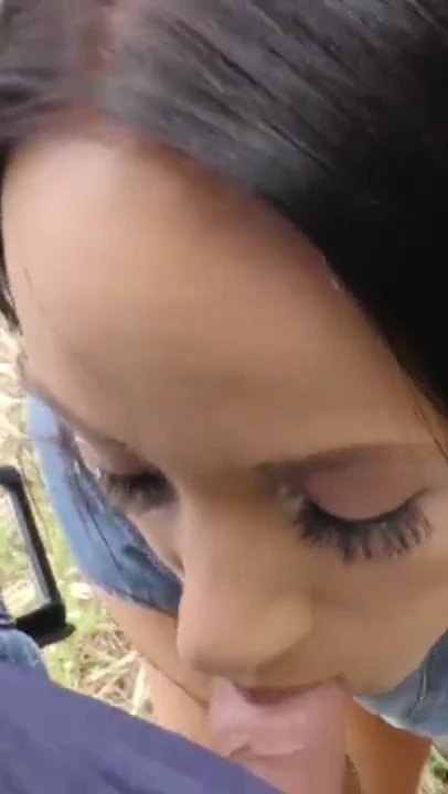 Black haired girl sucks thick cock outdoors in close-up